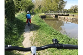 Arthur riding his bike on the canal path