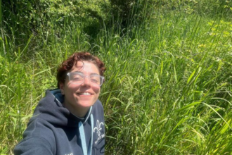 Young Ambassador Mary smiling in a sunny meadow