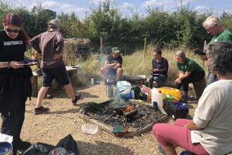 Group sit round a campfire