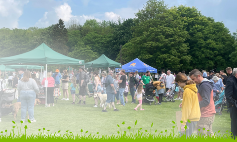 Visitors at last year's Country Comes to Town in park with marquees, with digital grass along the bottom