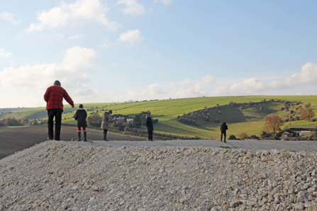 Photo of volunteers scattering seeds on the bank