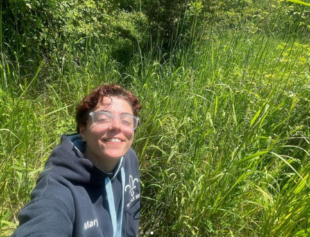 Young Ambassador Mary smiling in a sunny meadow