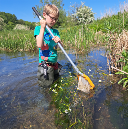 A child pond dipping in the river