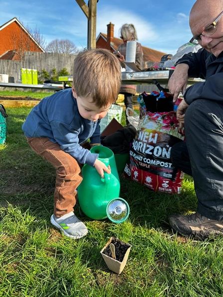 A child watering seeds