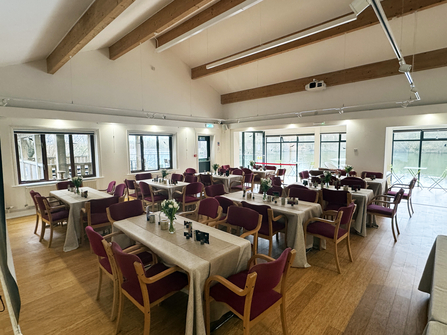 Brockbank Centre set up for a private function, with tables laid with tablecloths and chairs