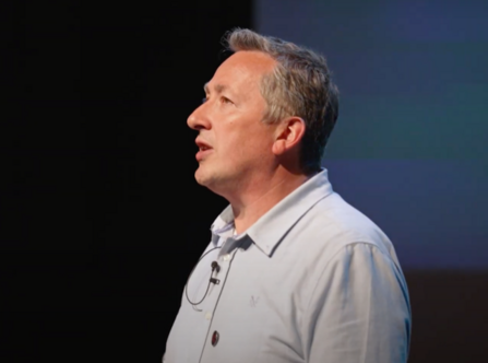 Side profile view of Damian, wearing grey shirt