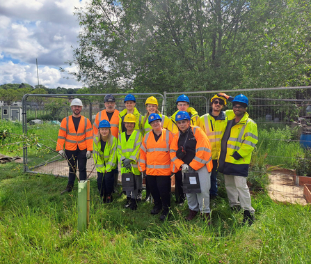 Group of volunteers in high vis smiling at camera in Westcott Garden