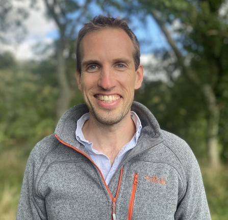 Headshot of Leo Henley-Lock, wearing a grey zipped jumper