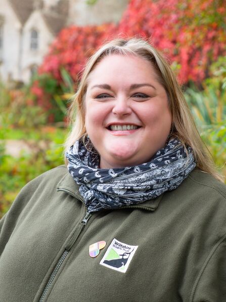 Head and shoulders photo of Carrie in green Trust fleece