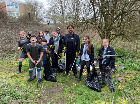 School group with litter pickers and rubbish bags