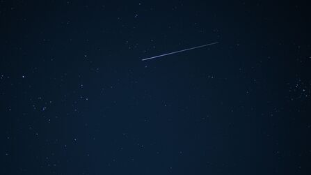 Shooting star in dark night sky