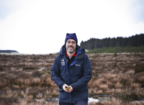 Duncan standing on a wetland